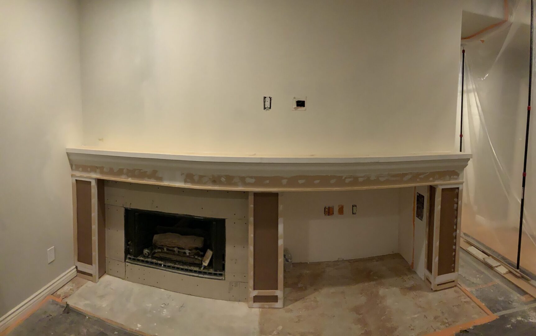 A fireplace in the middle of a room with no walls.