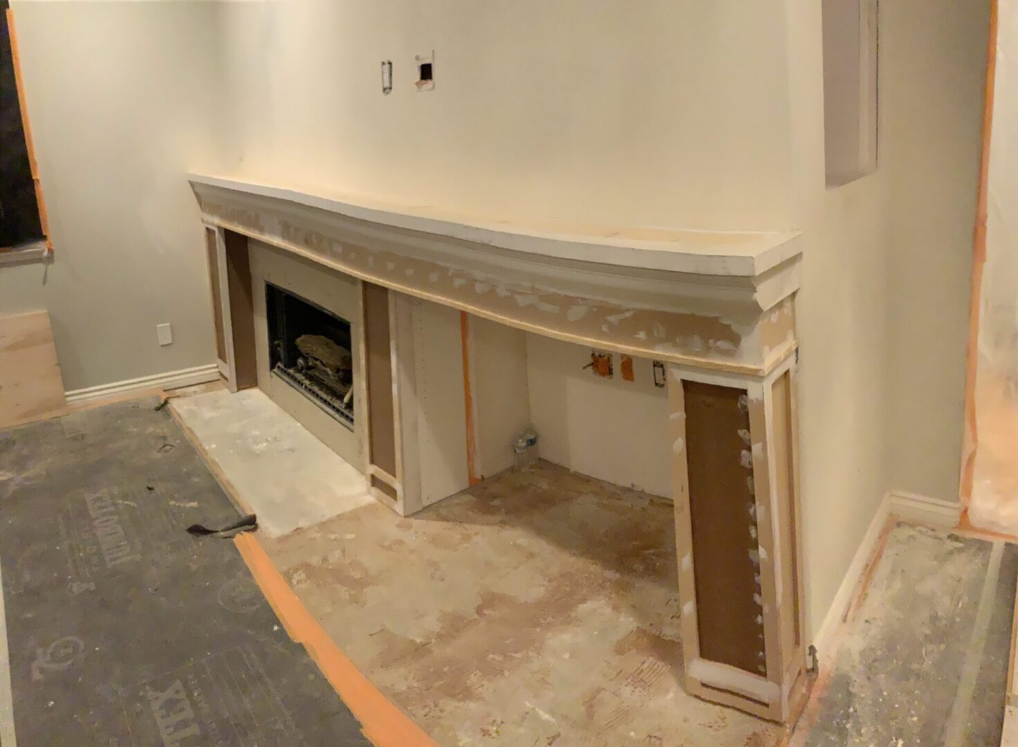 A fireplace mantle being built in the process of being painted.