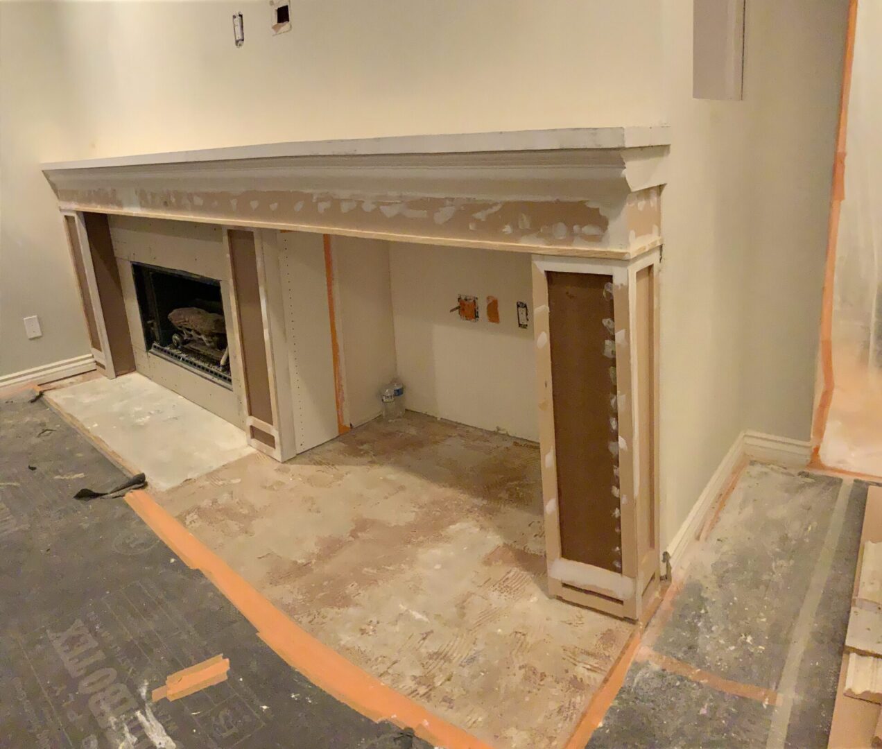 A fireplace being built in the middle of a room.