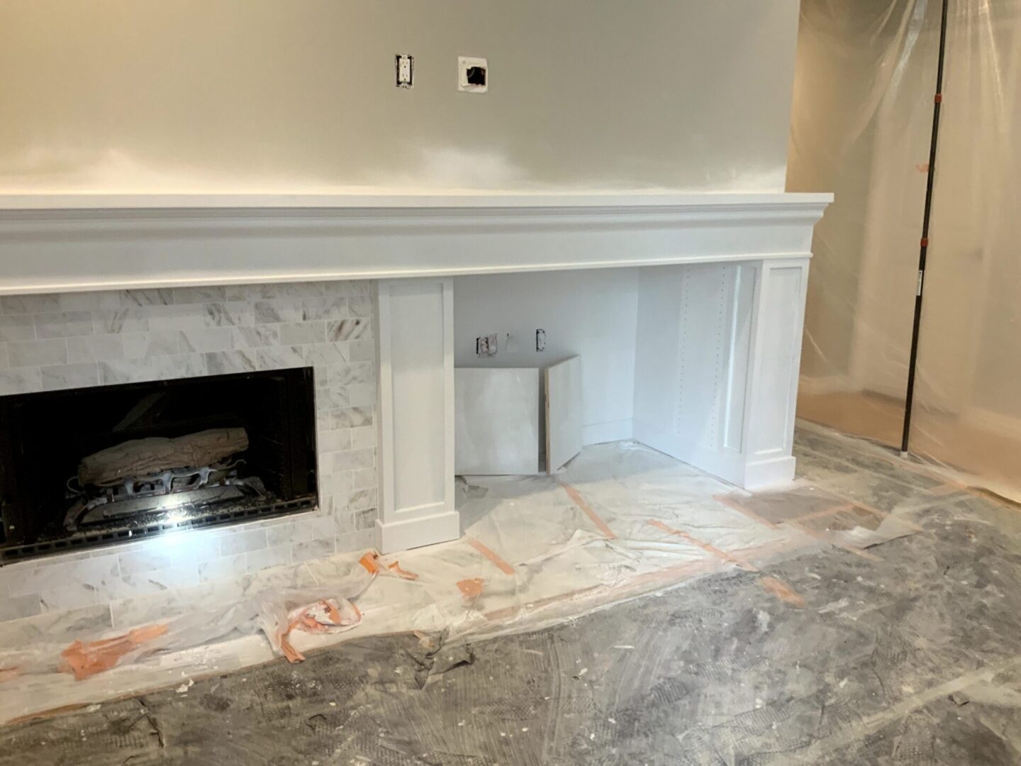 A fireplace in the middle of a room with marble floors.