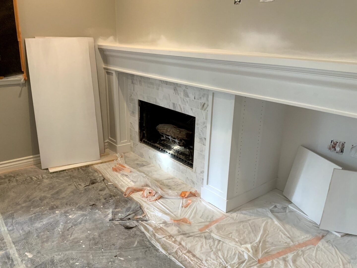 A fireplace in the corner of a room with paint on it.