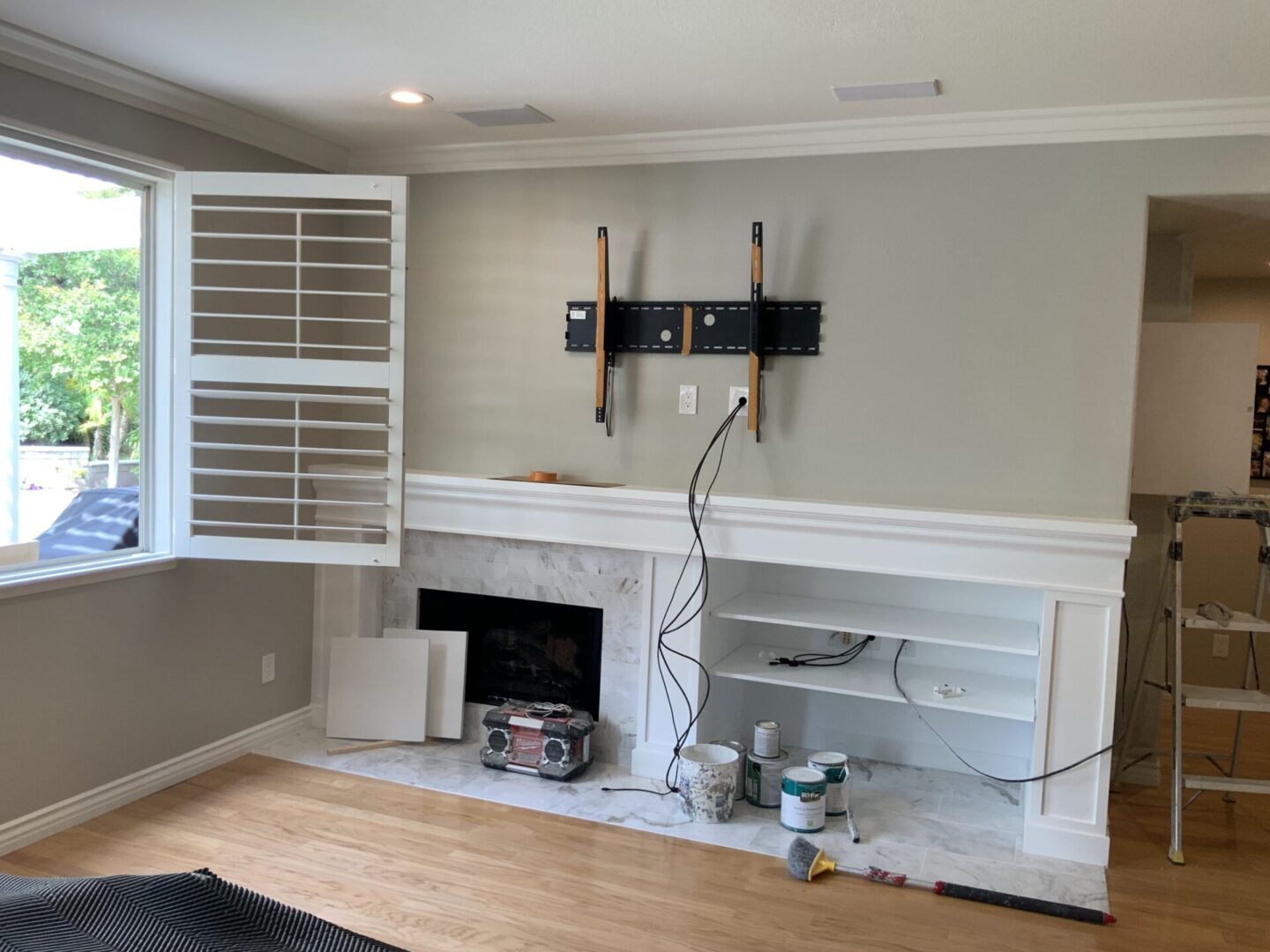 A room with a fireplace and television mounted on the wall.