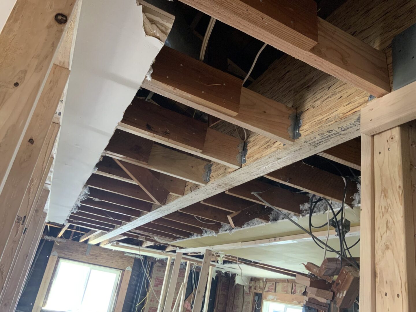 A room with wooden beams and ceiling joists.