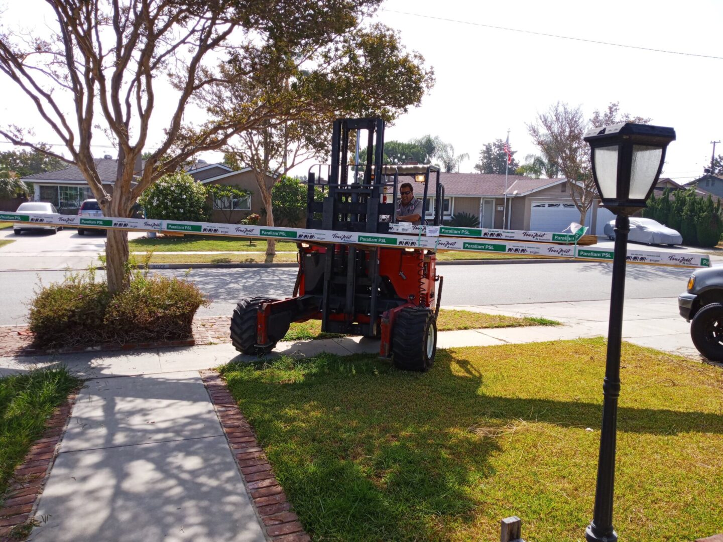 A forklift is parked on the side of the road.