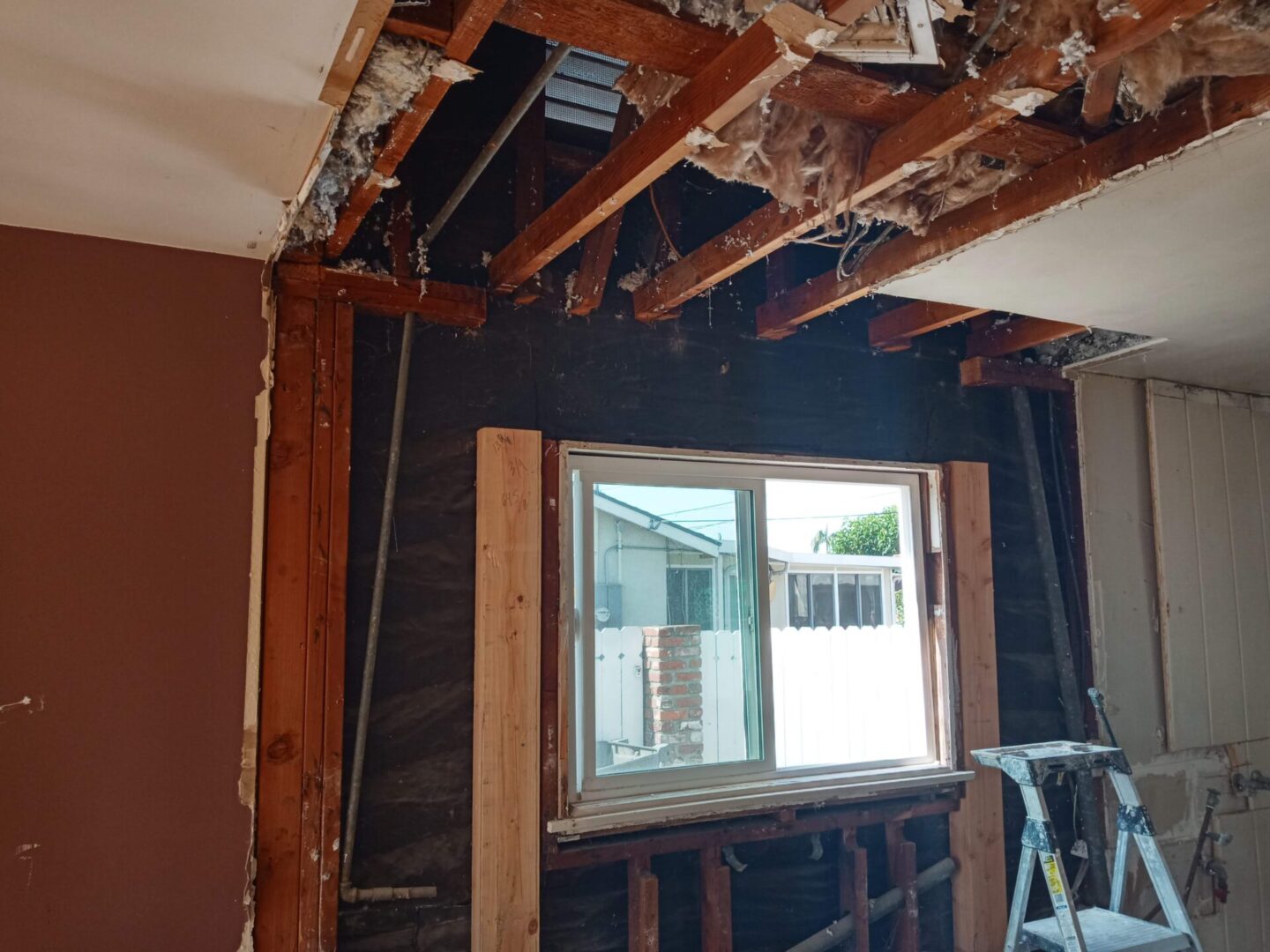 A room with a window and some wooden beams