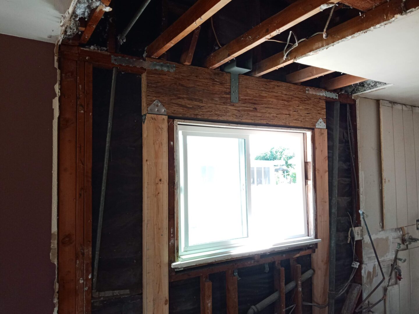 A room with some windows and wooden beams