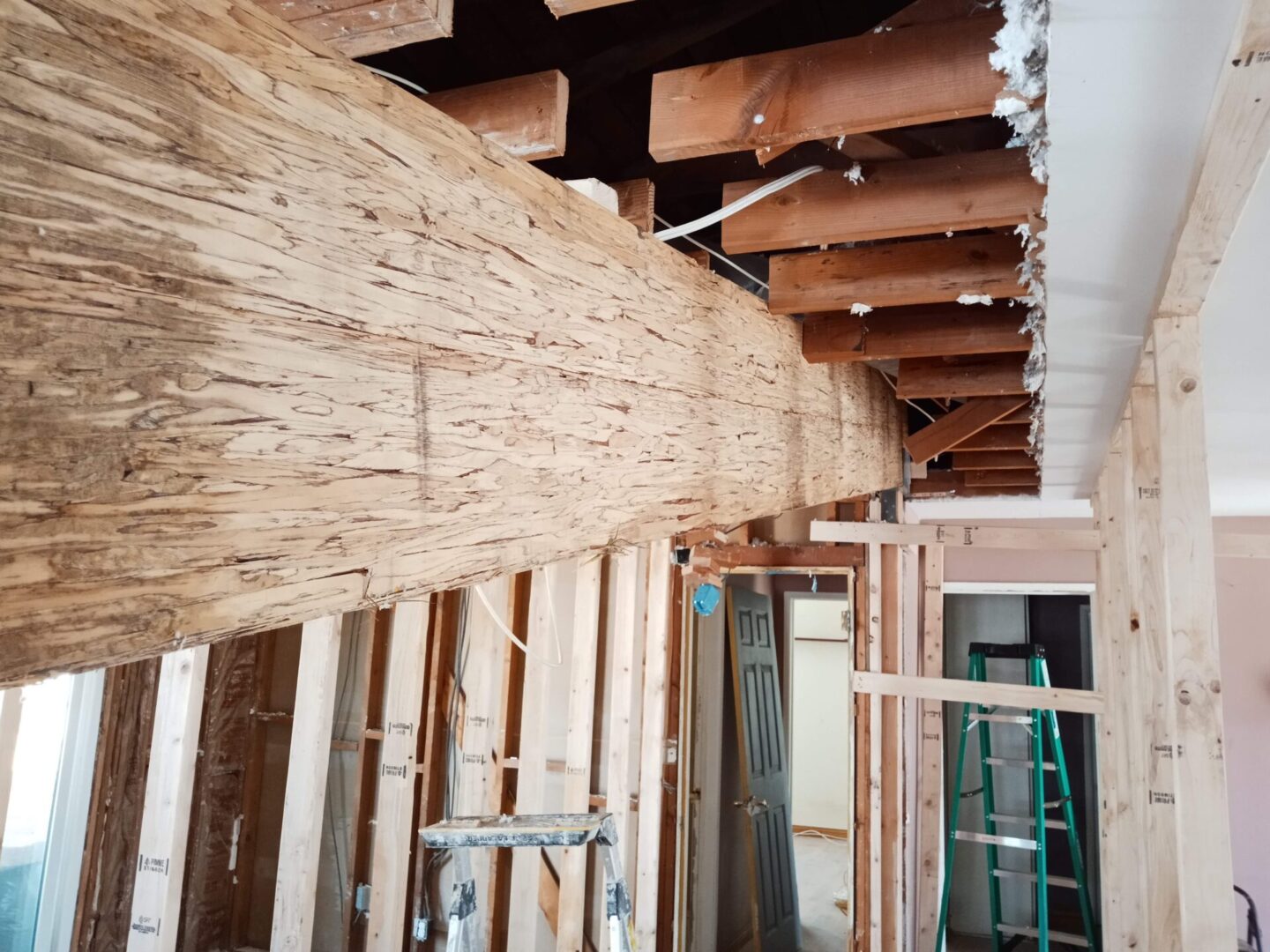 A building under construction with wood on the ceiling.