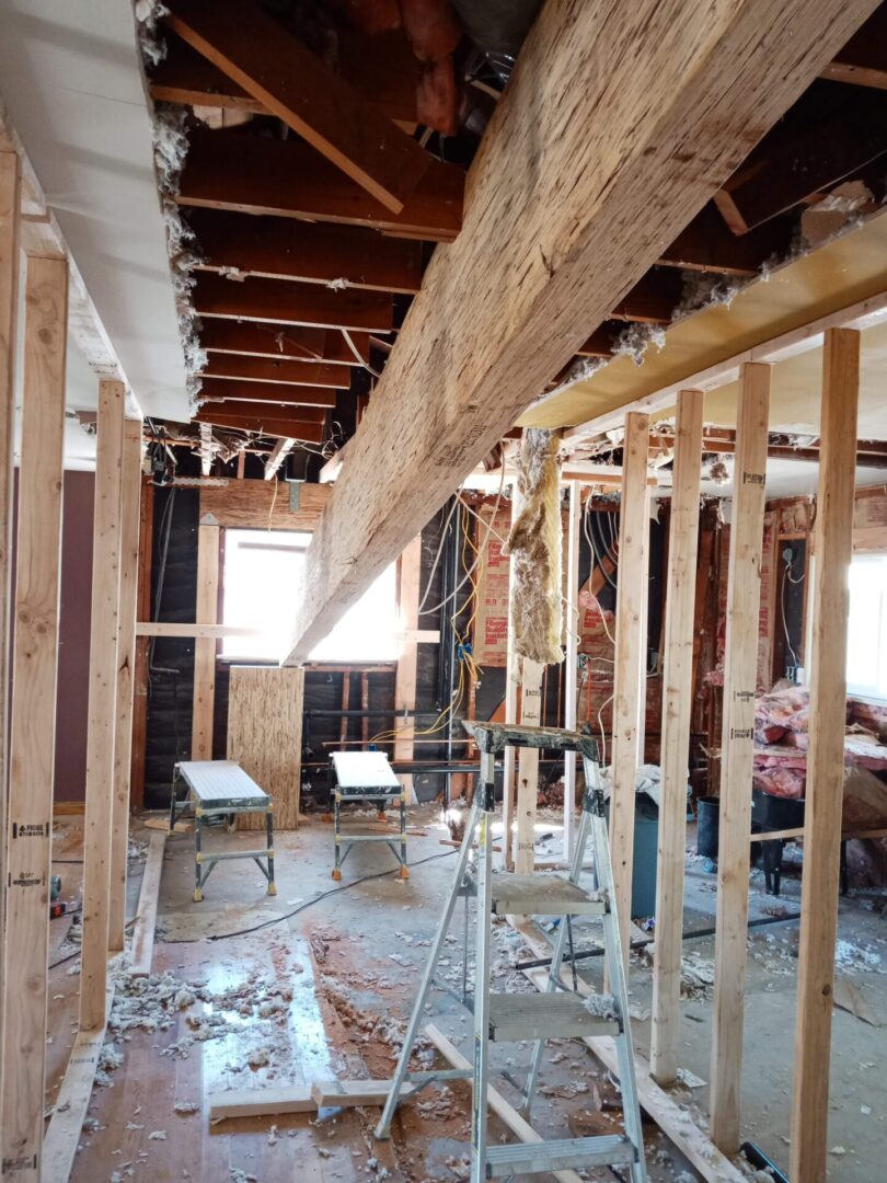 A room being remodeled with wood and beams.