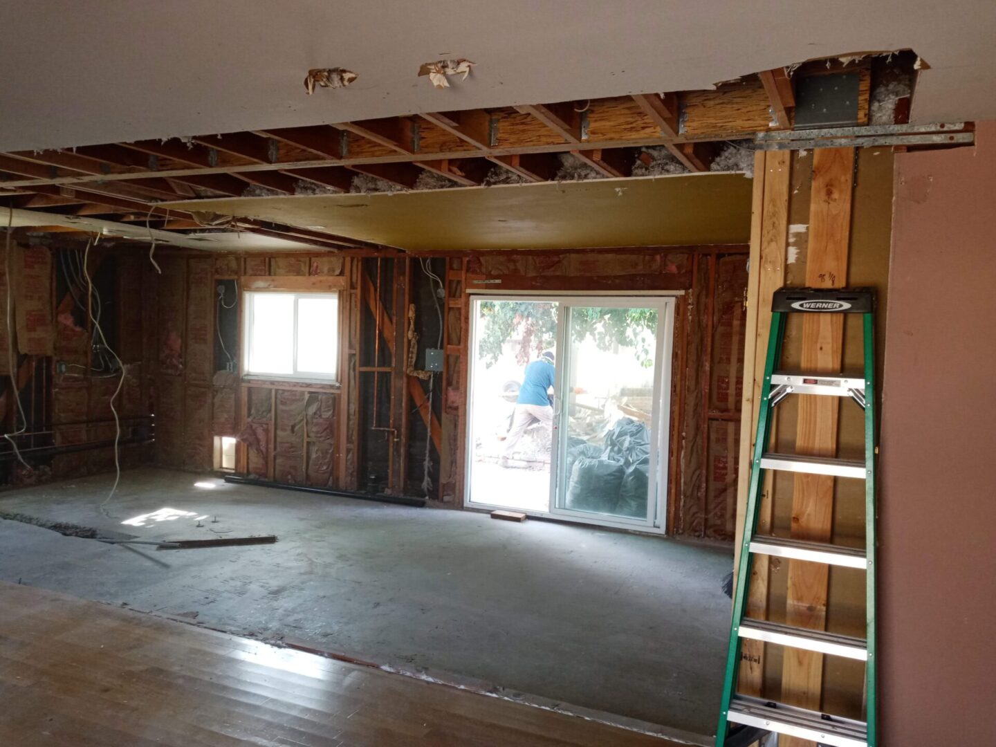 A room being remodeled with a ladder in the foreground.