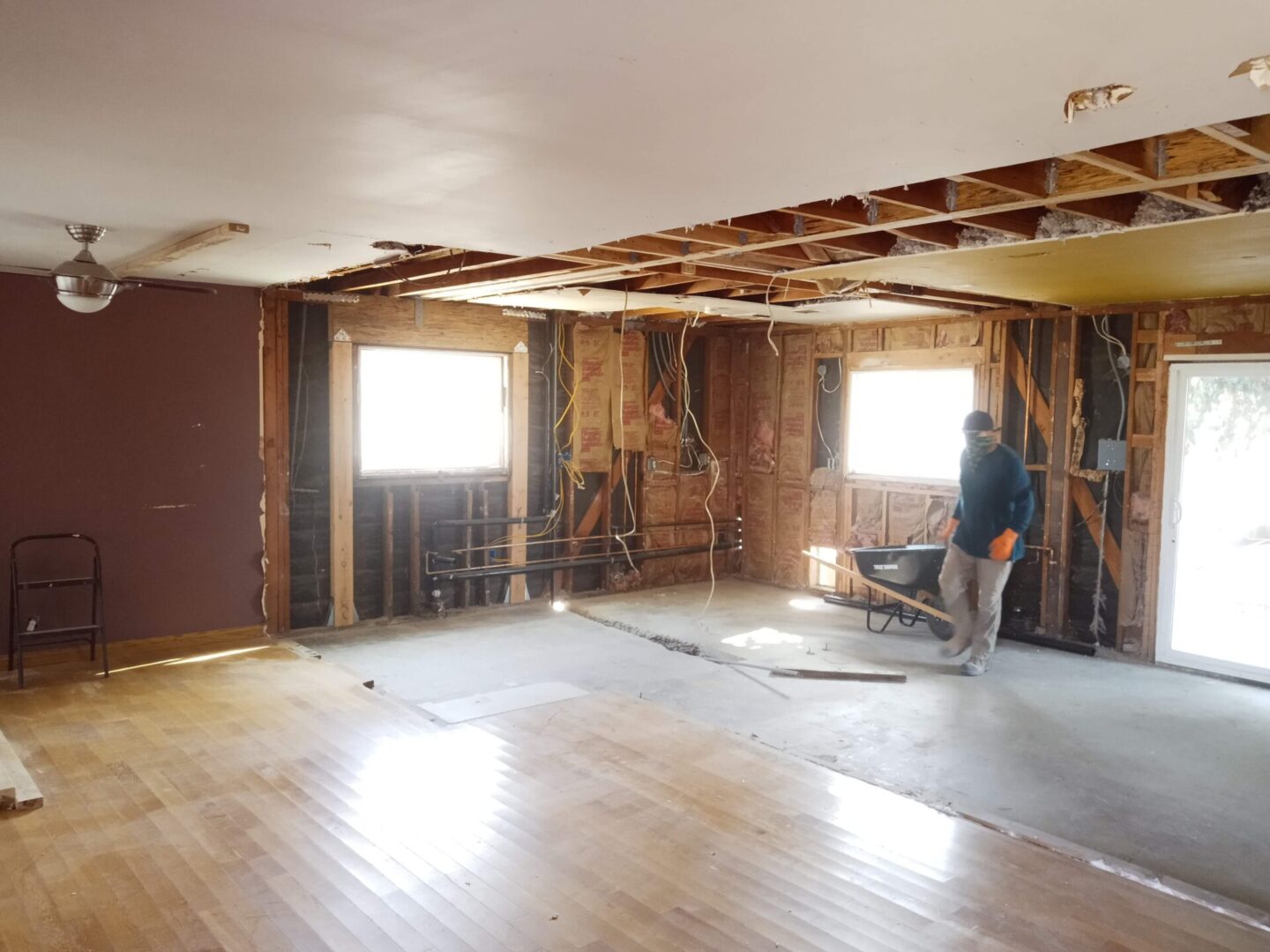 A man is working on the floor of his home.