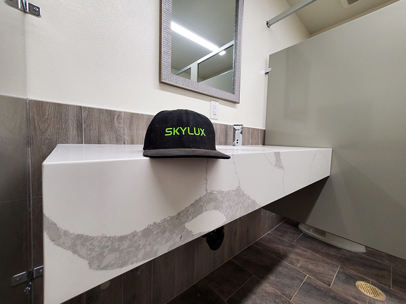 A bathroom with a sink and mirror in it