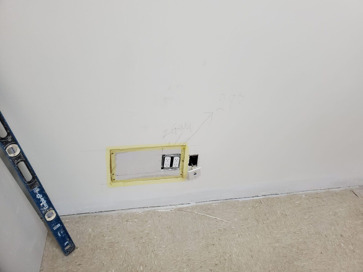 A wall with a yellow frame and a blue ruler