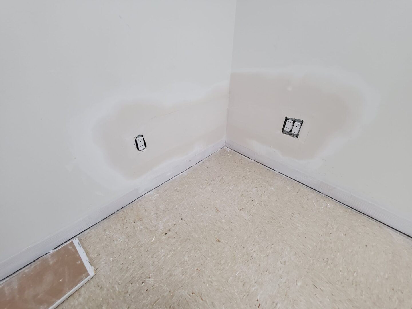 A room with white walls and no carpet.