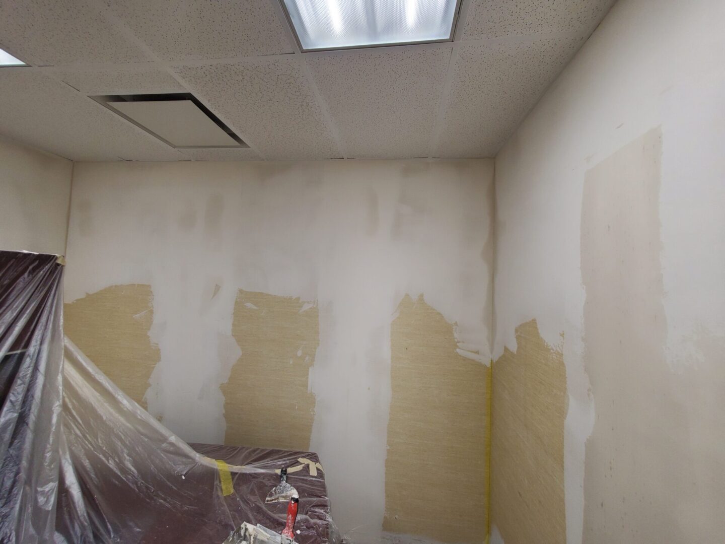 A room with walls painted white and covered in paint.