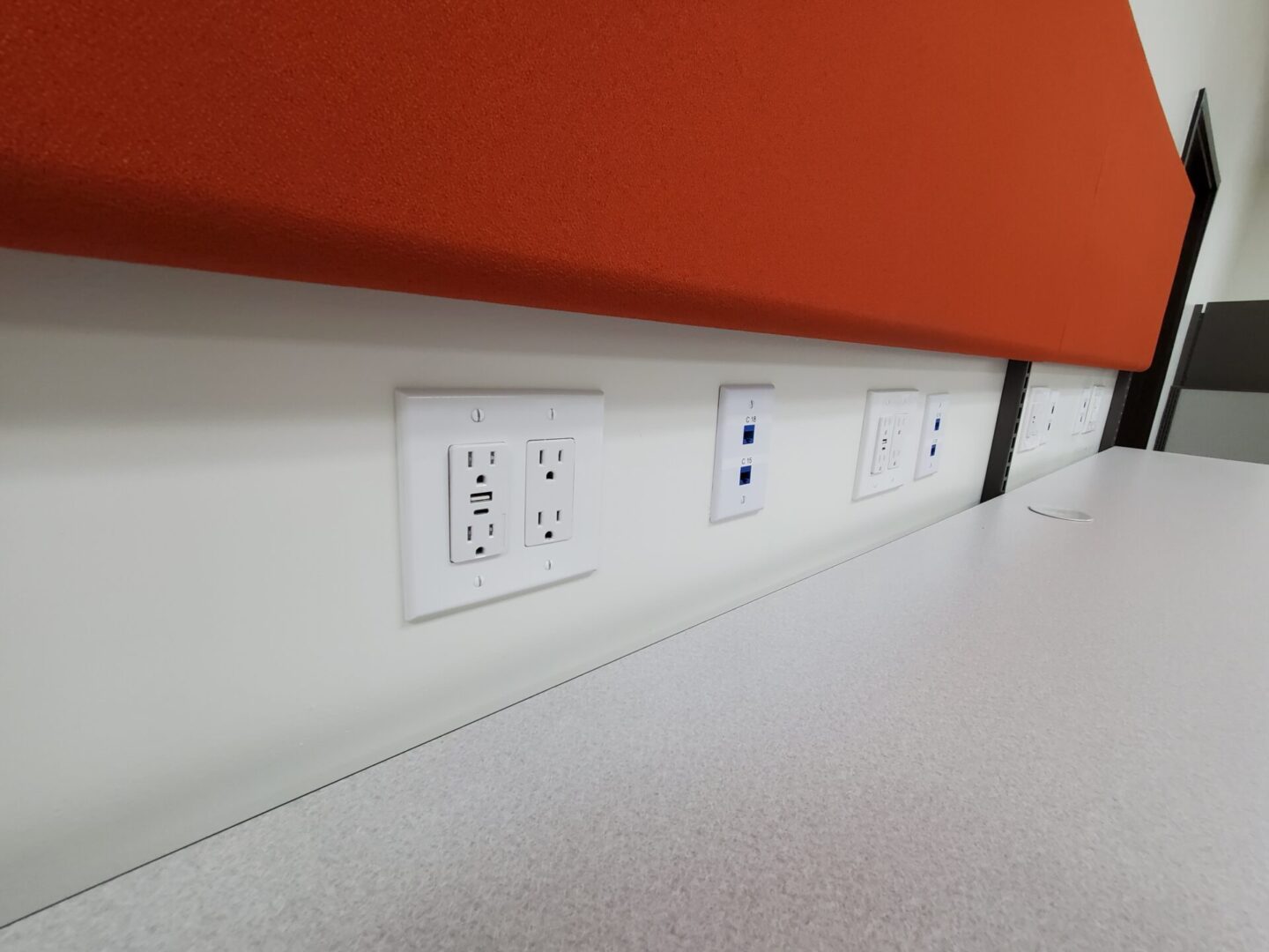 A row of electrical outlets on the wall.