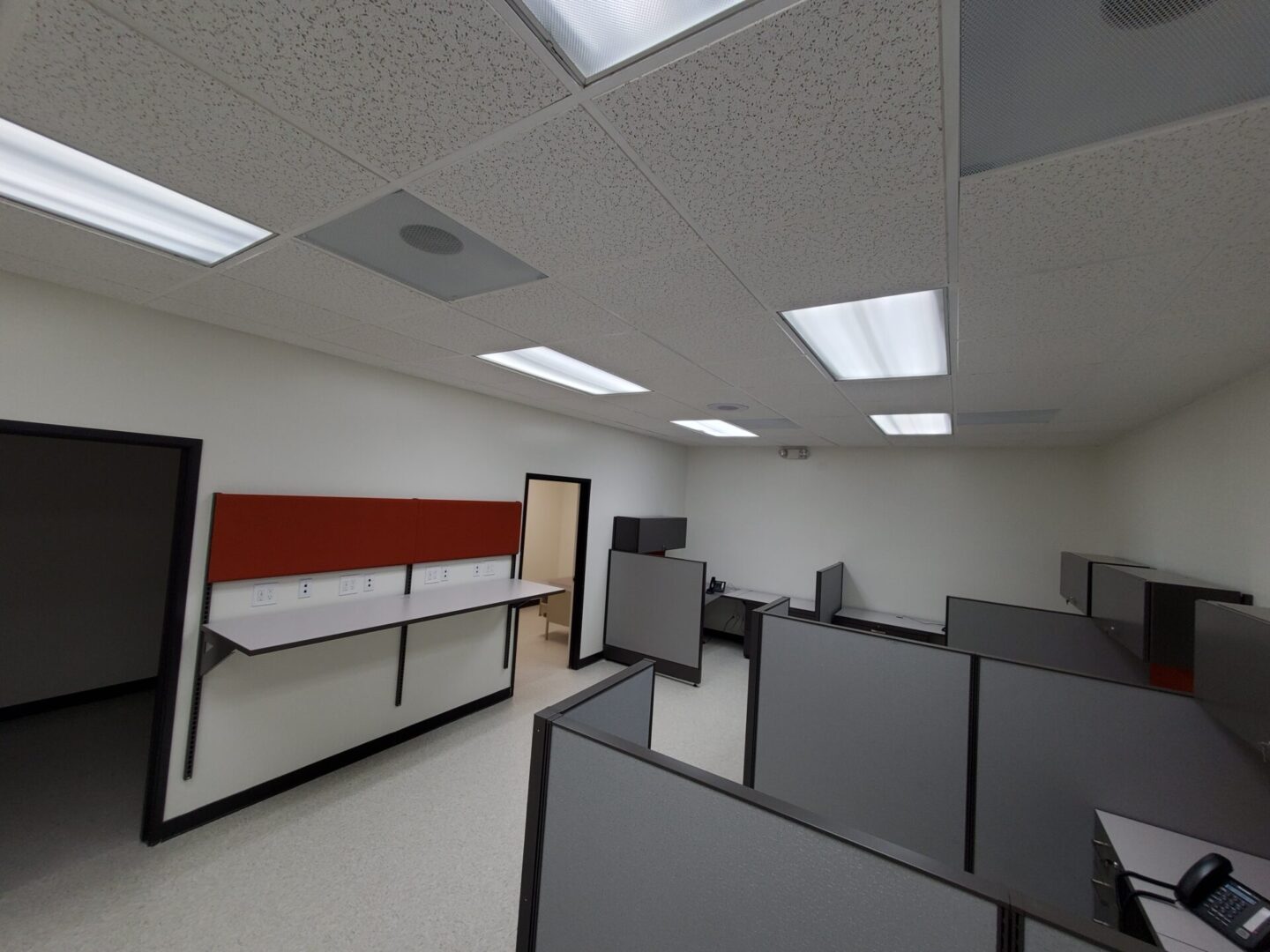 A large office with many cubicles and desks.