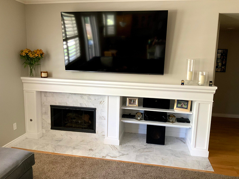 A fireplace with a tv mounted above it