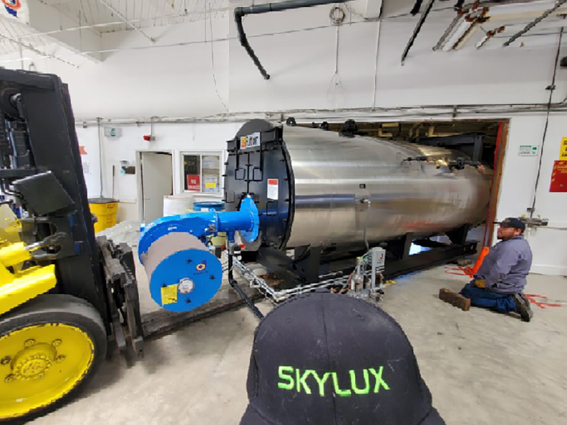 A man is working on the skylux machine.