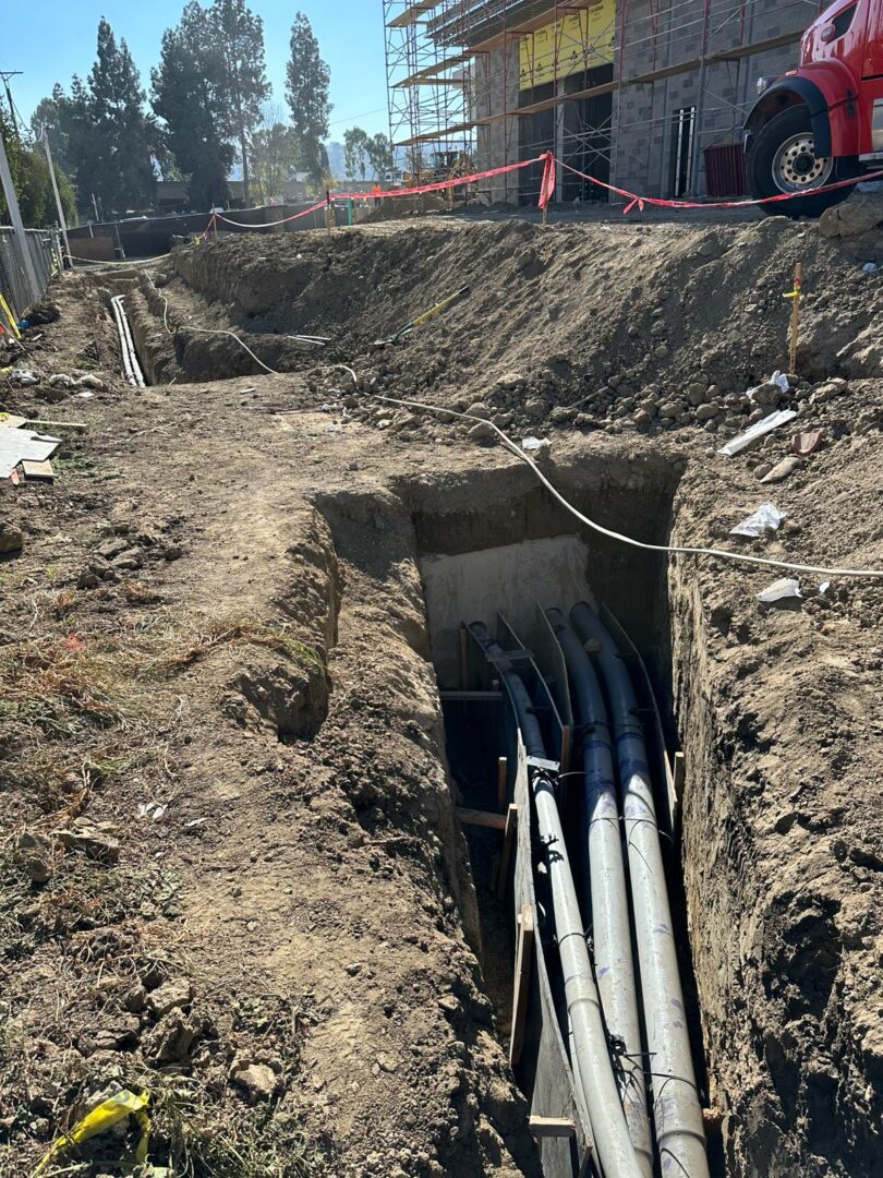 A trench with pipes in it is being dug.