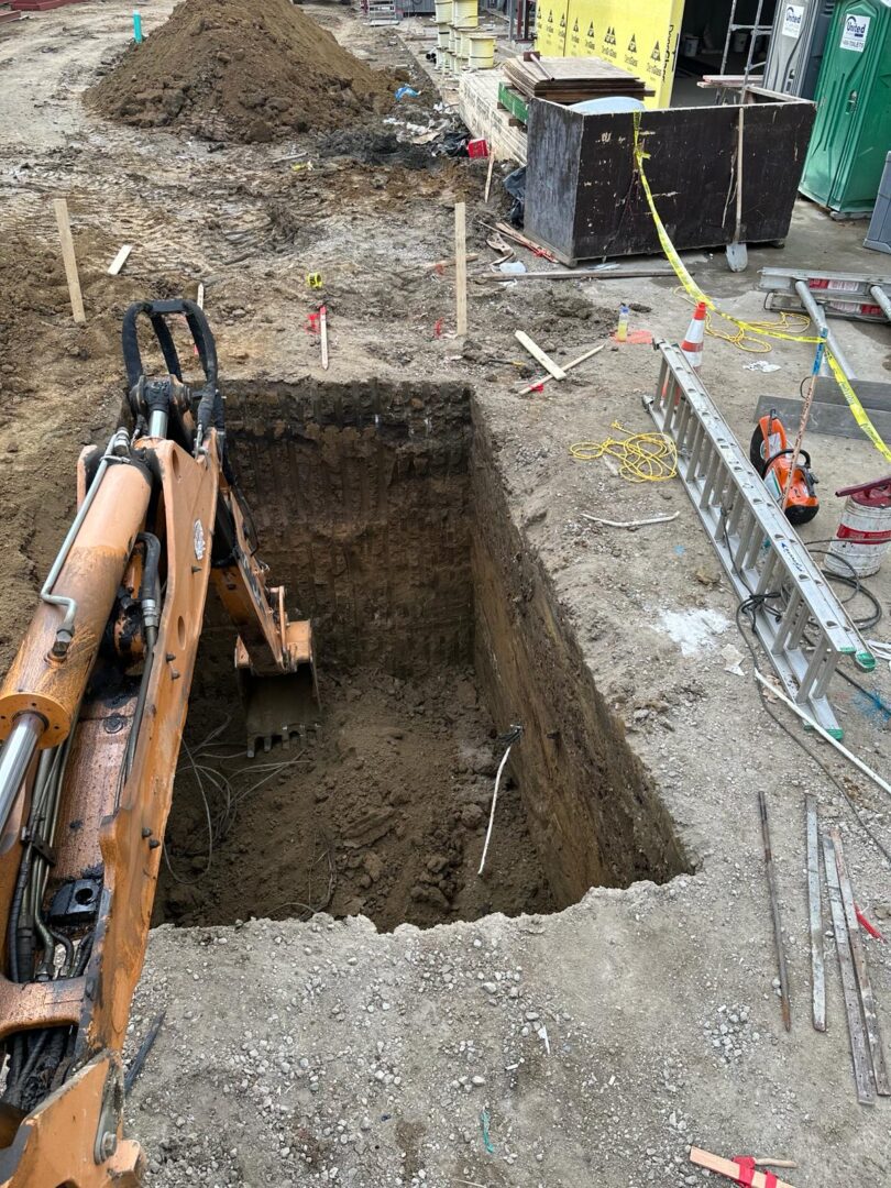 A large hole in the ground with a crane on it.