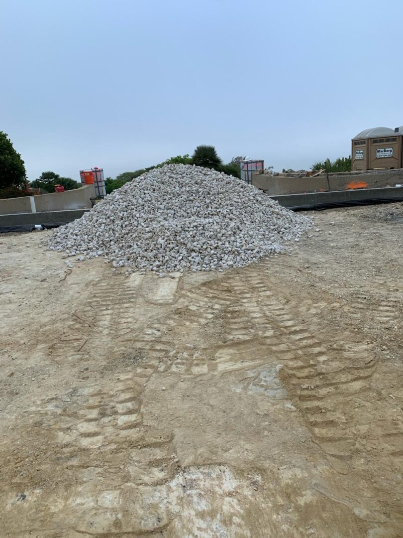 A pile of gravel on top of the ground.