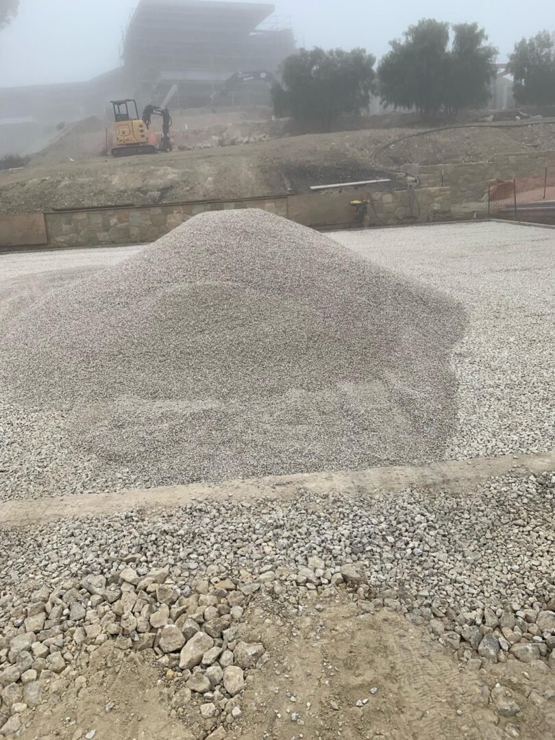 A pile of gravel sitting on top of a road.