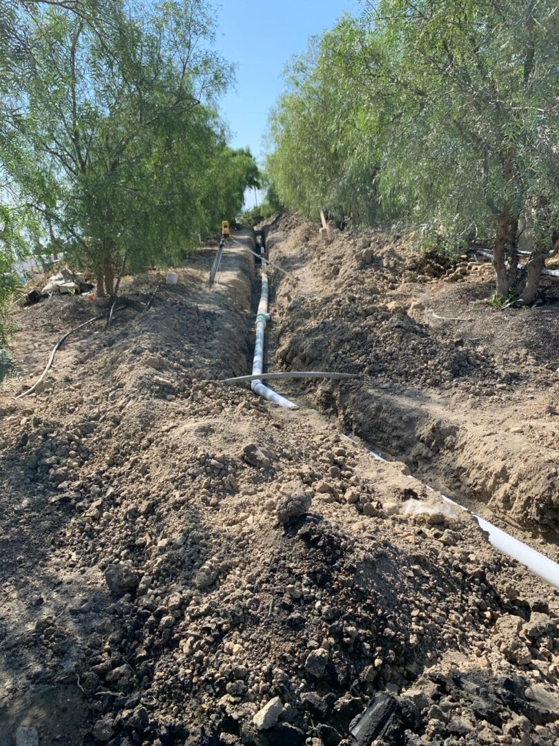 A dirt hill with water pipes running through it.