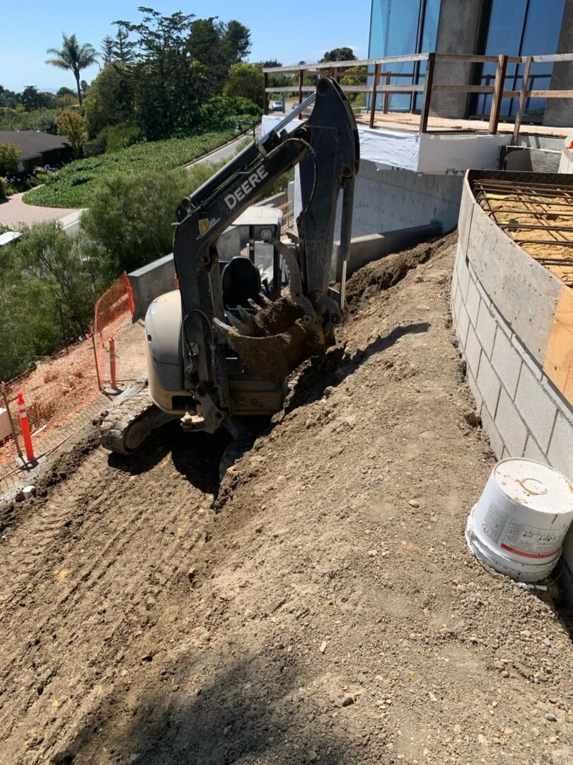 A construction site with a backhoe and bucket.