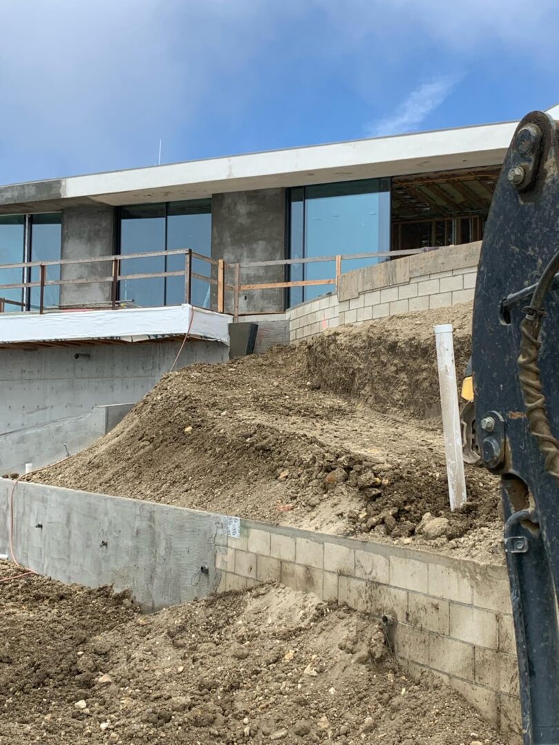 A bulldozer is parked on the side of a building.